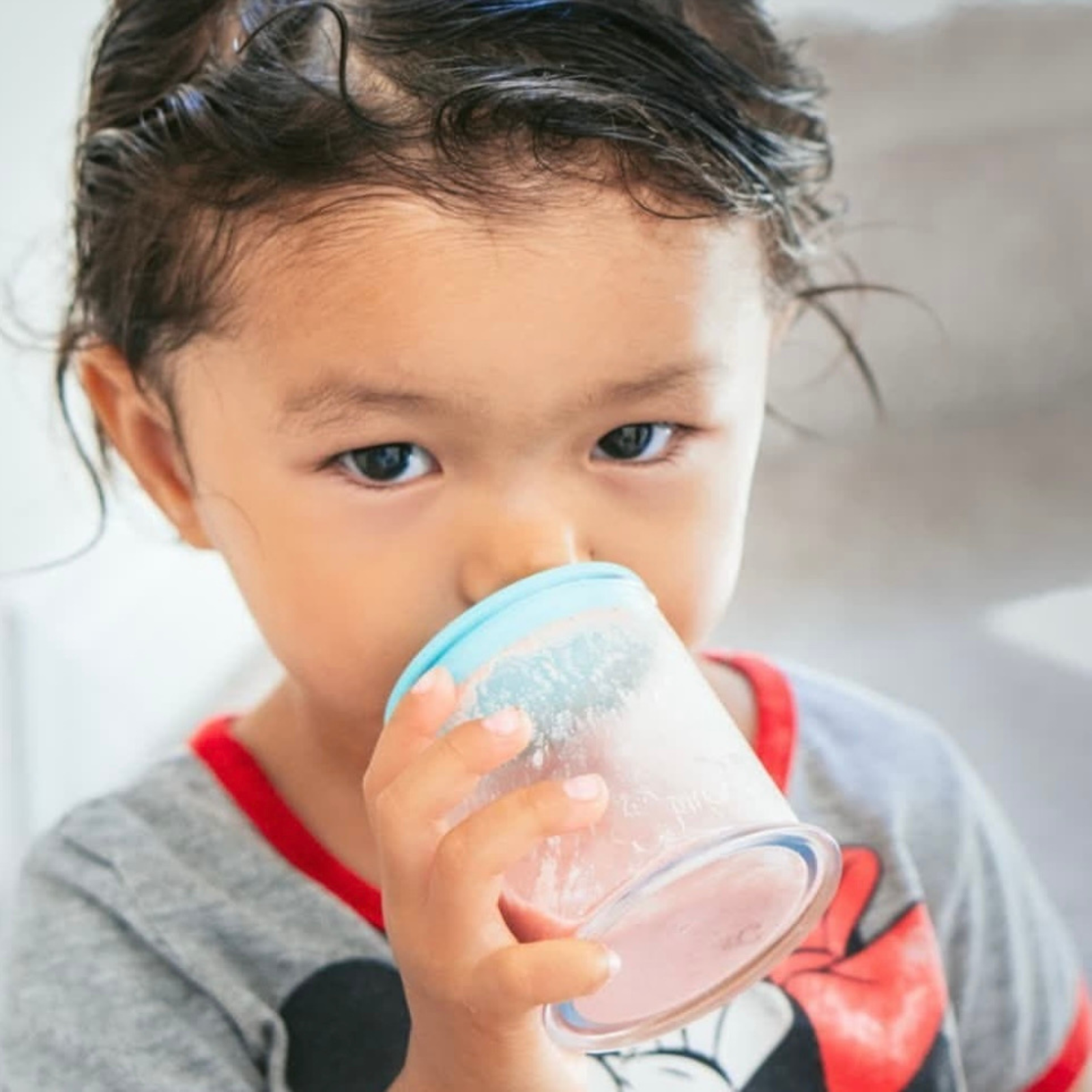 Toddler drinking from the grabease straw cup