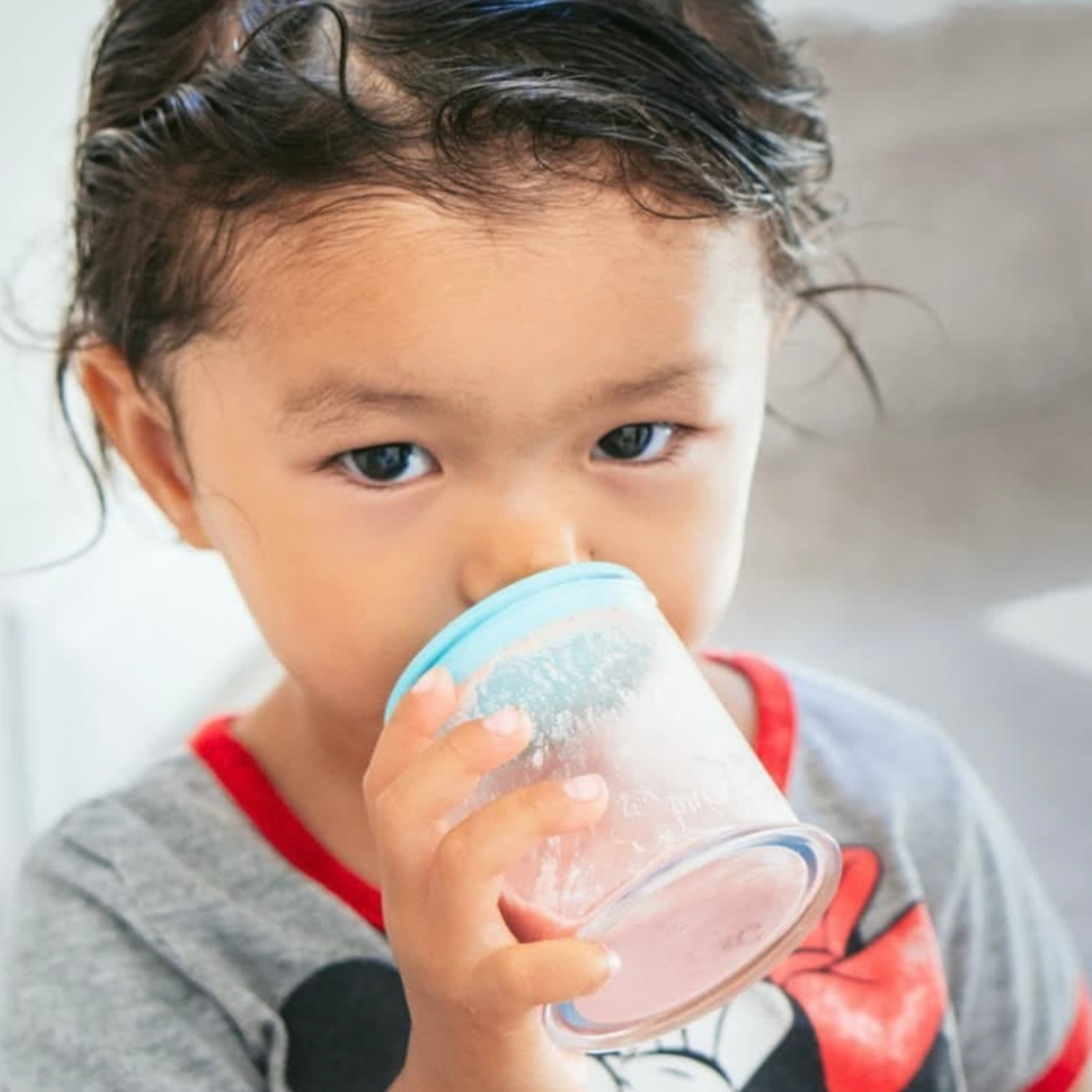 Toddler drinking from the grabease sippy cup