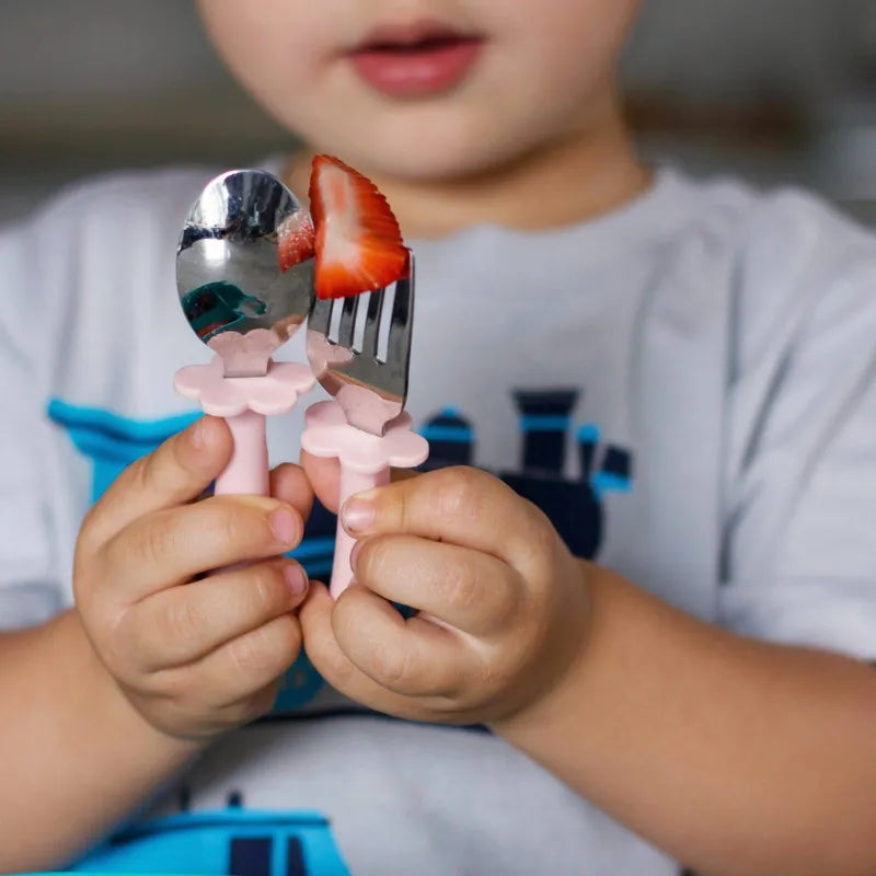 Toddler holding Pink Stainless Steel Spoon and Fork Set – Stage 3